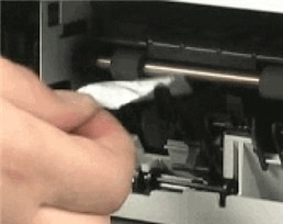 Photograph of removing torn pieces of paper from rollers