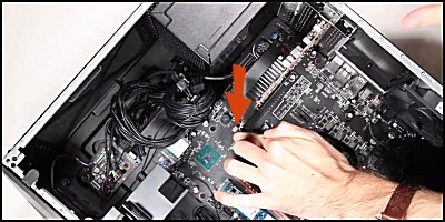Pressing down on the retaining lever to release graphics card