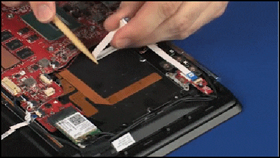 Removing the power button board ribbon cable from the adhesive on the top cover