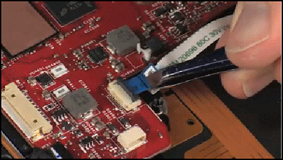 Inserting the power button board ribbon cable into the ZIF connector