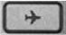 A keyboard button with an icon of an airplane on it.
