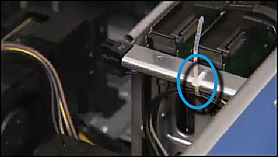 Securing the graphics card power cables to the side of the bottom internal hard drive cage with a zip tie