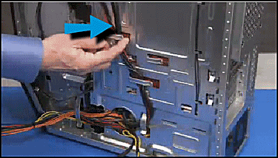 Pulling the optical drive and upper hard drive power connectors out of their cable guides
